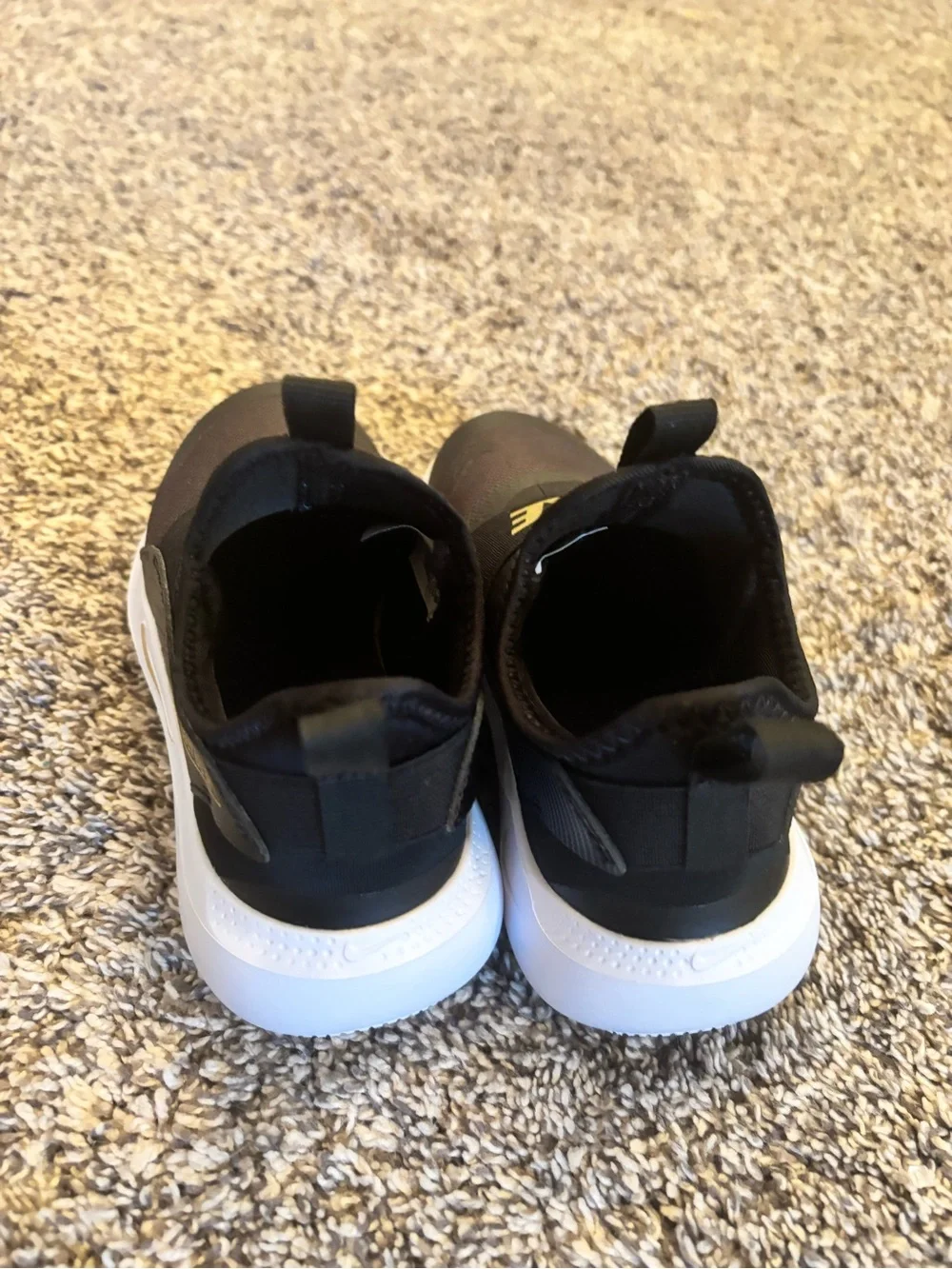 Nike Kids Black Slip-On Sneakers with Gold Logo Strap